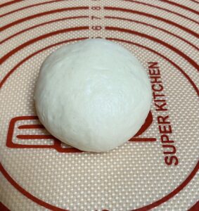 Shaping dough for low sodium hamburger dun into a ball